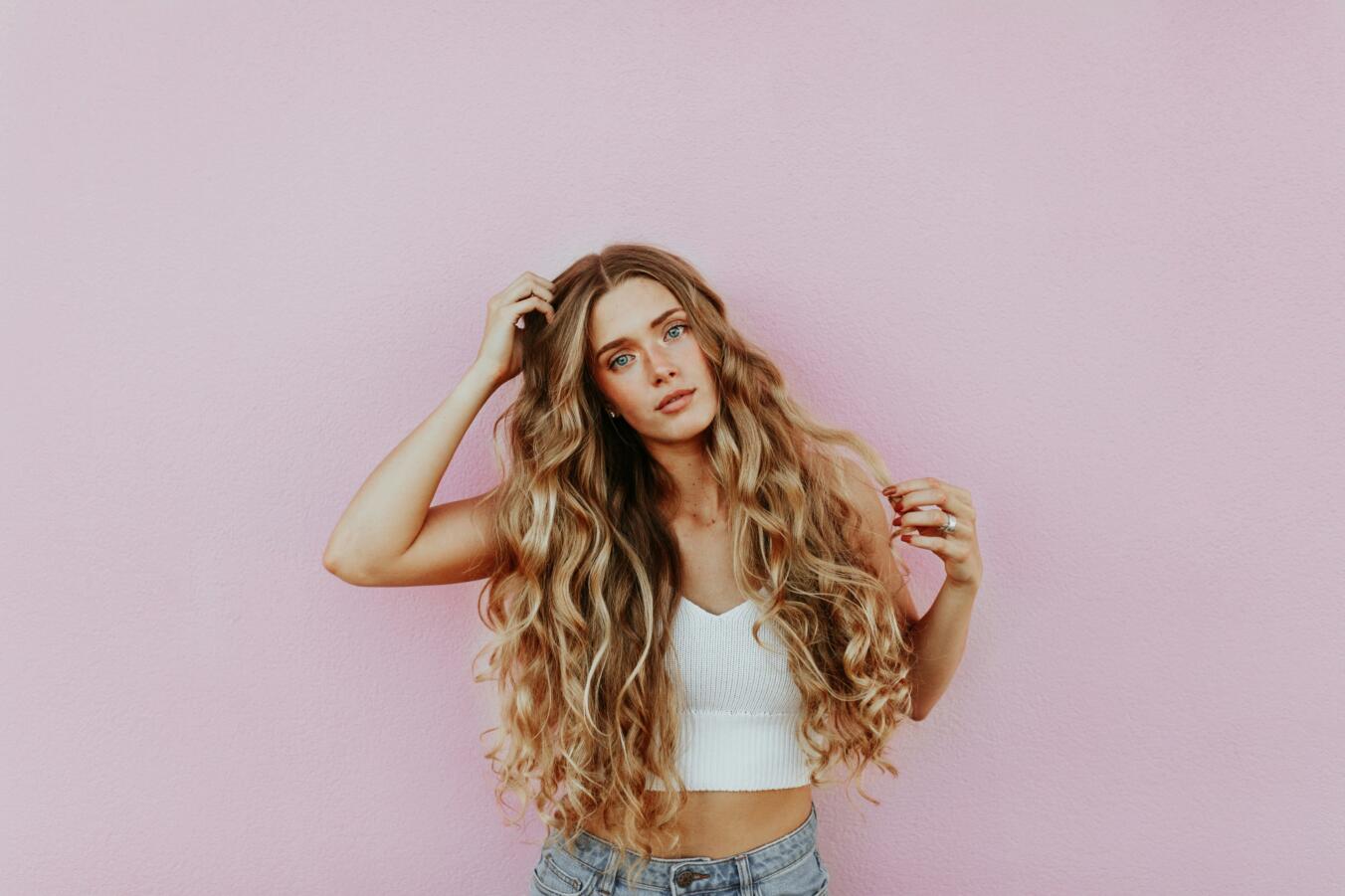 Young woman with long, healthy, curly blonde hair 