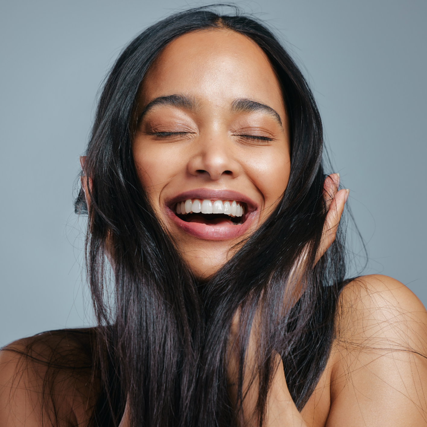 Smiling young woman with shiny, healthy hair