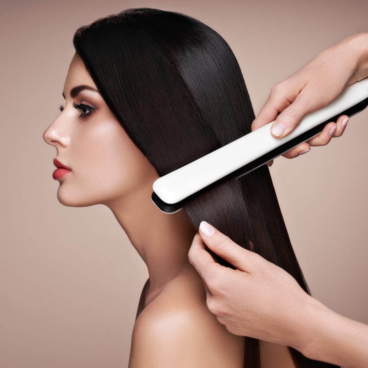 Woman having her hair straightened