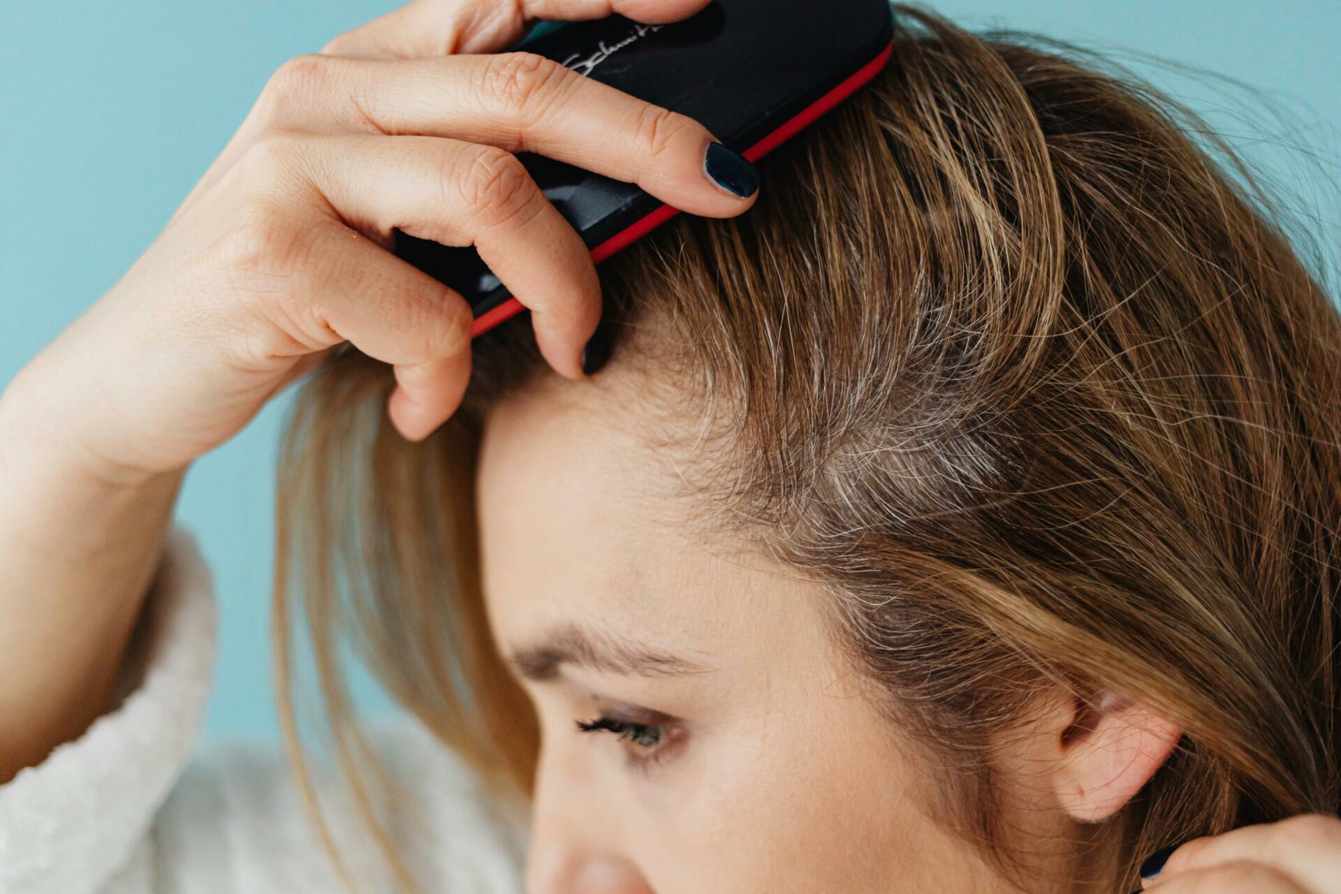 Older woman brushing through her hair