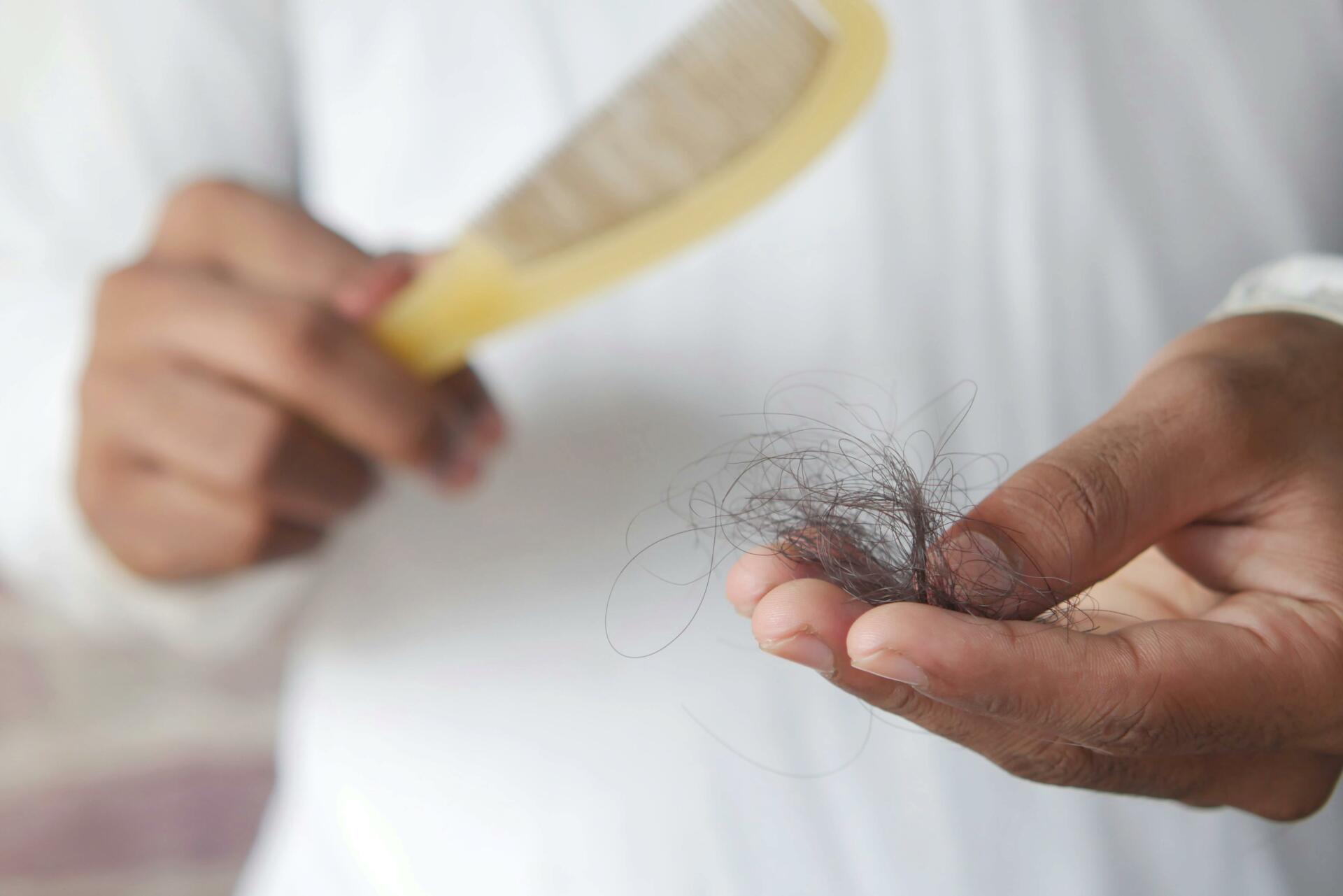 Man with comb brushing out loose hair