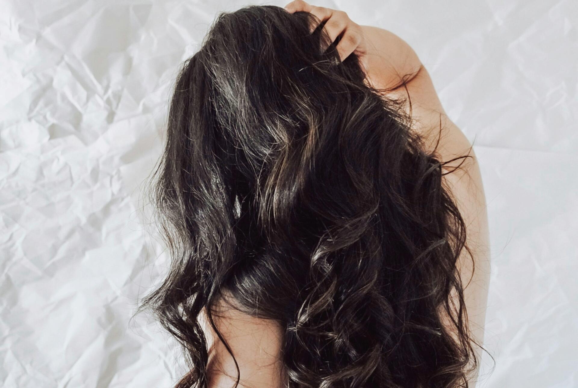 Woman with thick, dark curly hair.