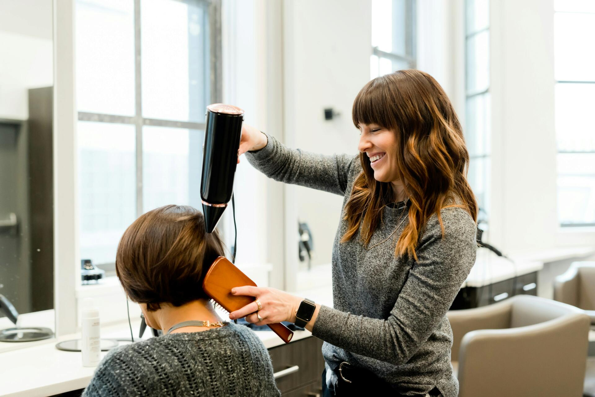 Woman getting her hair cut and styled at a salon