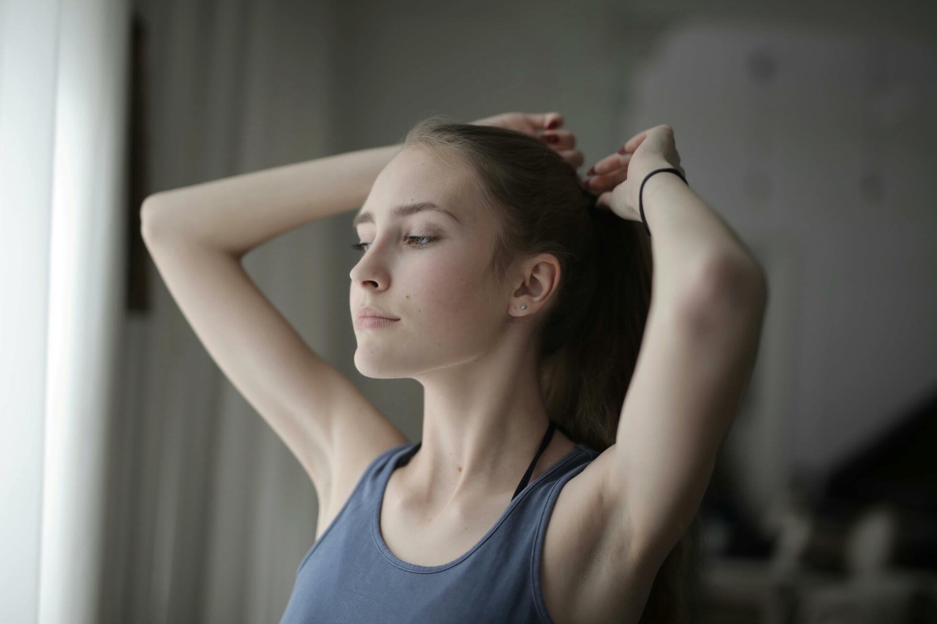 Young woman tying her hair up