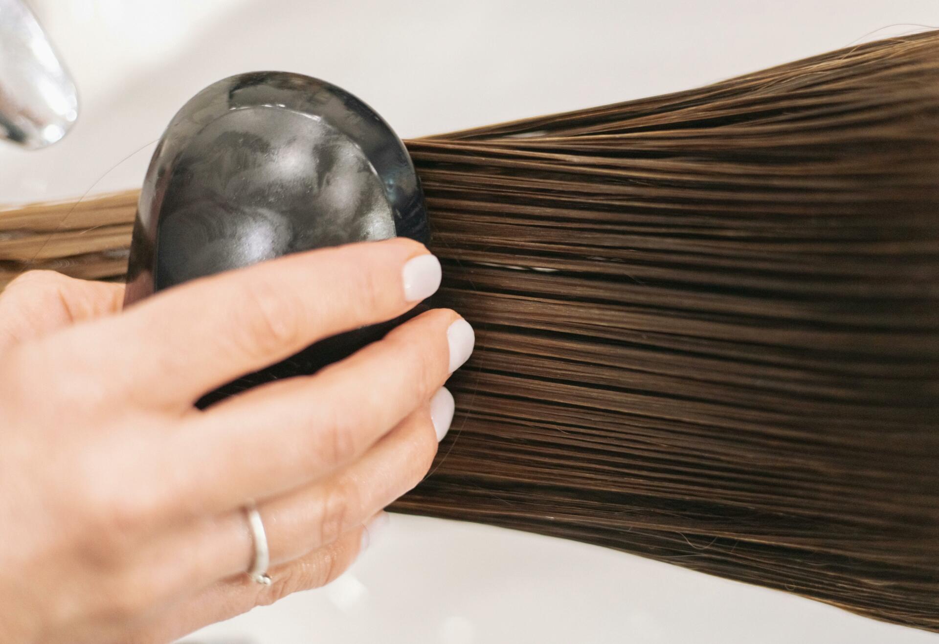 Woman combing through wet hair