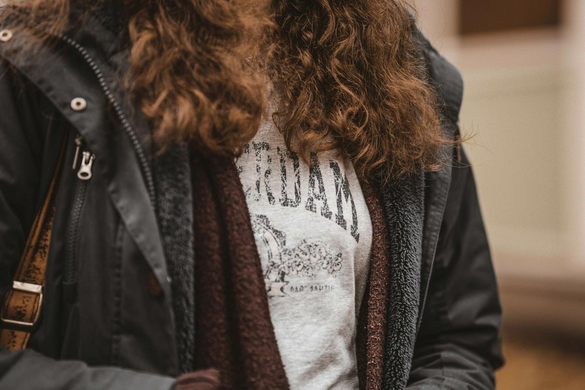 Young woman struggling with frizzy curly hair
